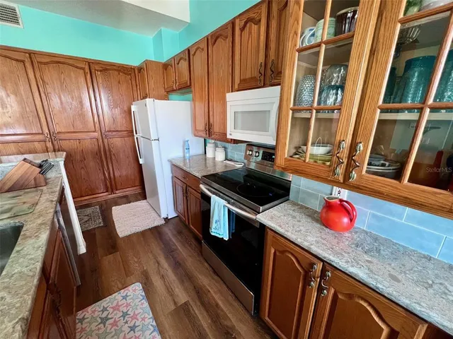 a view of a balcony with wooden floor and city view