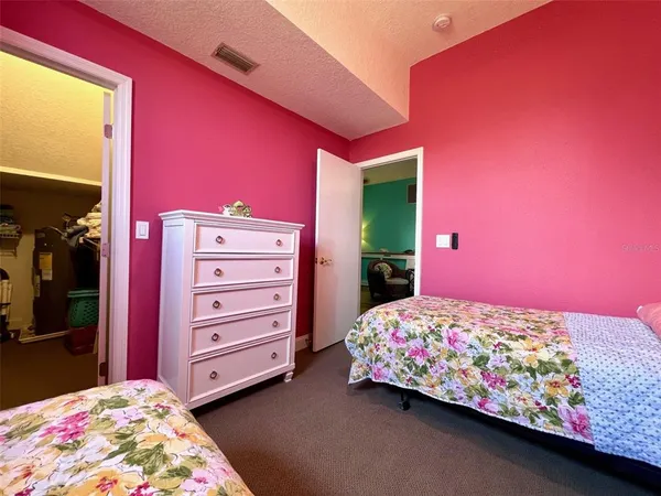 a kitchen with stainless steel appliances granite countertop a refrigerator a stove a sink and white cabinets with wooden floor