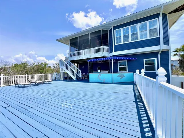 a view of house with outdoor space and palm trees