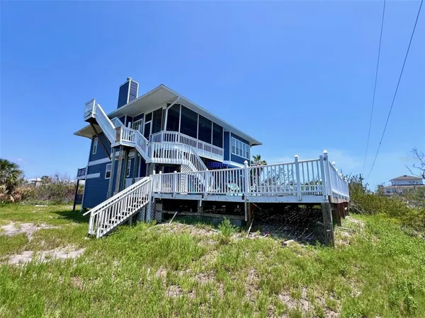 a living room with furniture a window and wooden floor