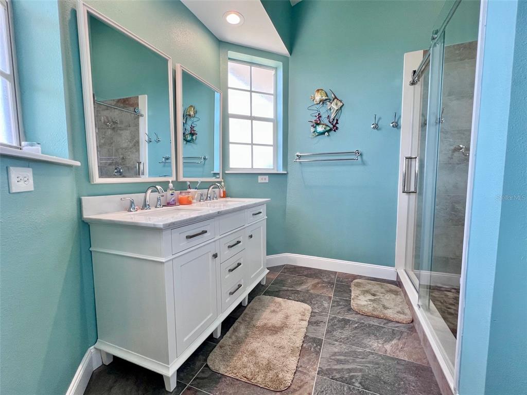 9594 Doubloon Trail Placida, FL 33946 - Photo 63 of 84 a bathroom with a sink mirror and a bath tub