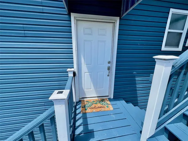 a living room with furniture a rug and a chandelier