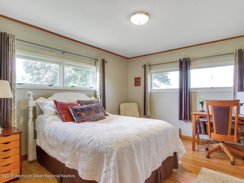 60 Five Points Road Colts Neck, NJ 07722 - Photo 13 of 37 a bedroom with a balcony a bed and a dresser next to a window