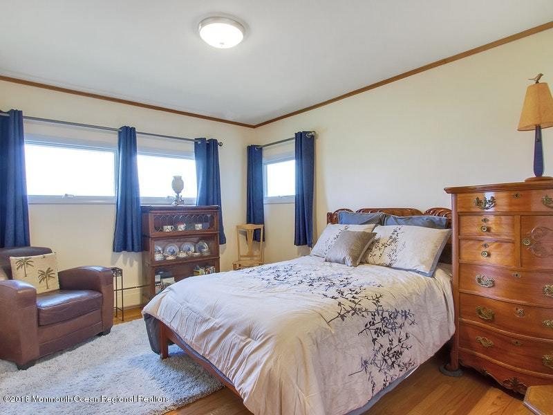 60 Five Points Road Colts Neck, NJ 07722 - Photo 15 of 37 a large bedroom with a bed and wooden floor