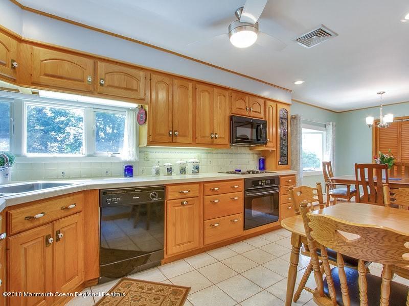 60 Five Points Road Colts Neck, NJ 07722 - Photo 7 of 37 a kitchen with stainless steel appliances granite countertop a stove top oven a sink dishwasher and cabinets with wooden floor