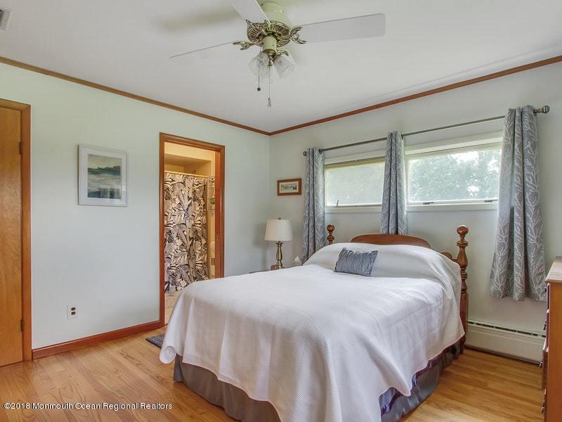 60 Five Points Road Colts Neck, NJ 07722 - Photo 10 of 37 a bedroom with a bed and a chandelier