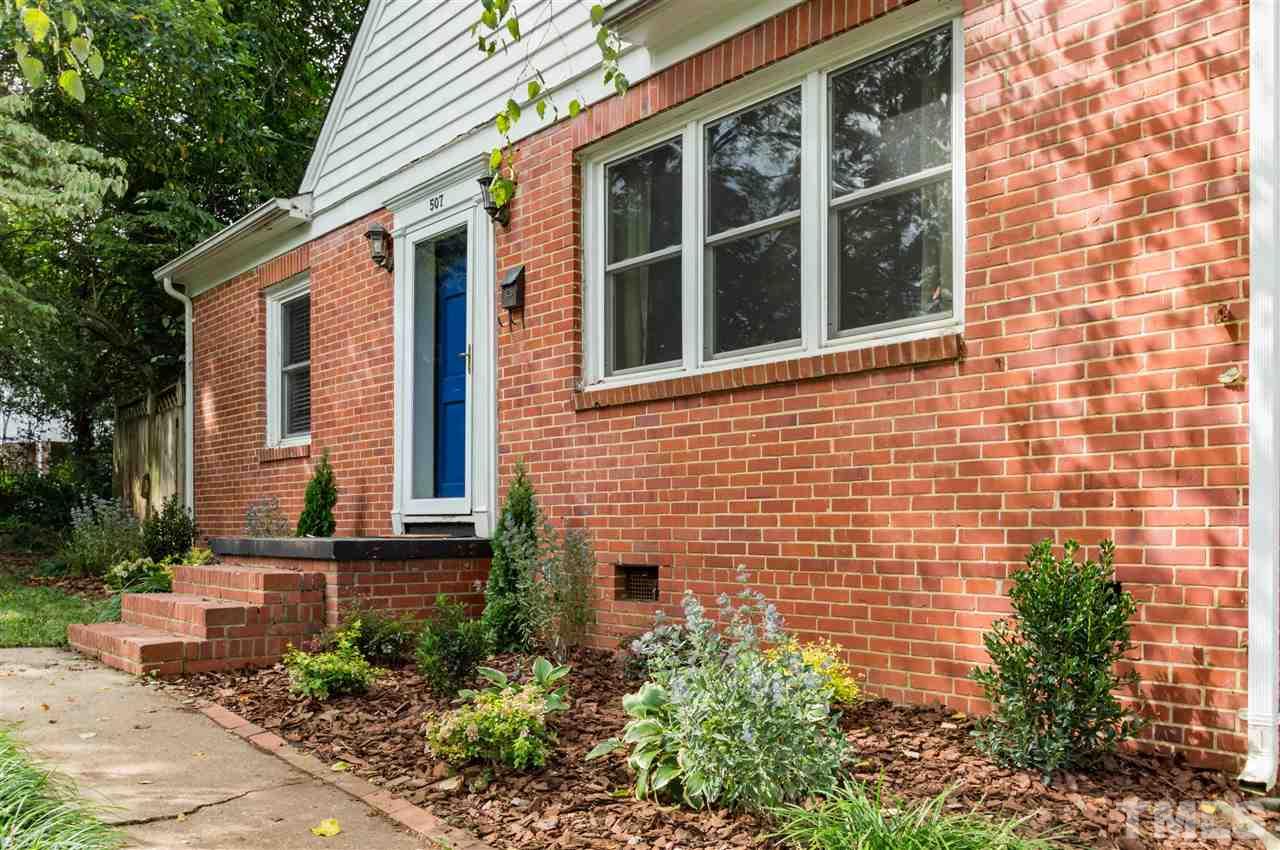 507 Brooks Avenue Raleigh, NC 27607 - Photo 2 of 20 a view of a brick house with a large windows