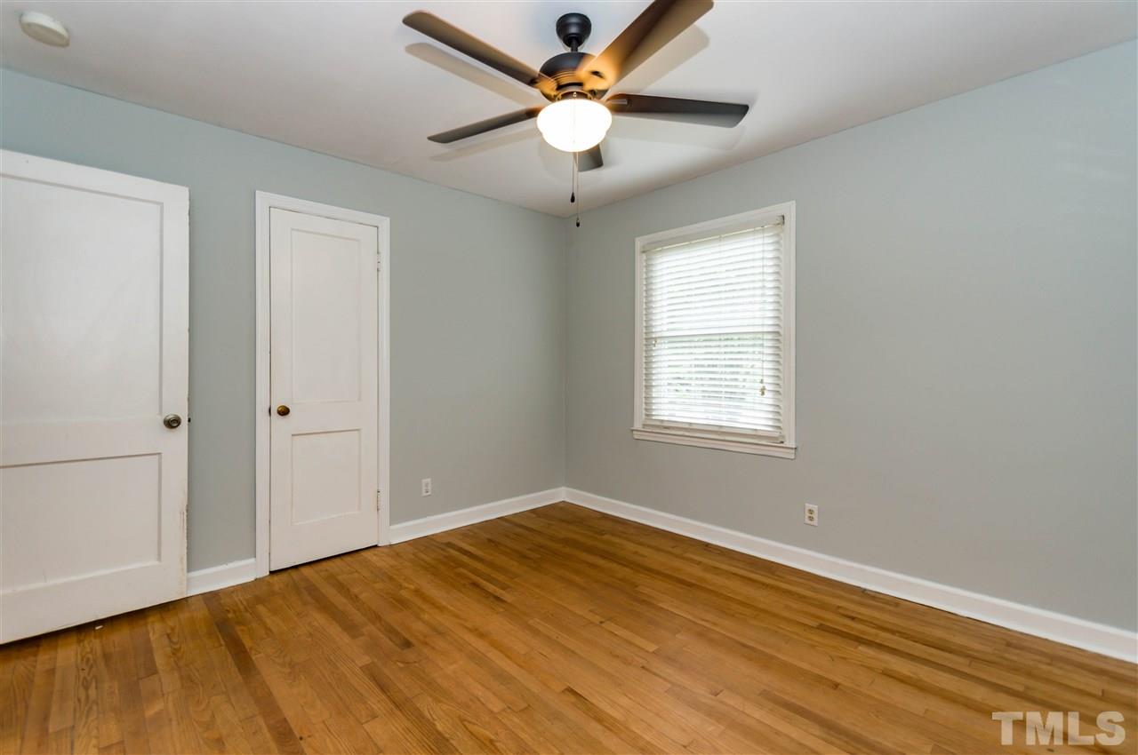 507 Brooks Avenue Raleigh, NC 27607 - Photo 13 of 20 a view of an empty room with window and a chandelier fan