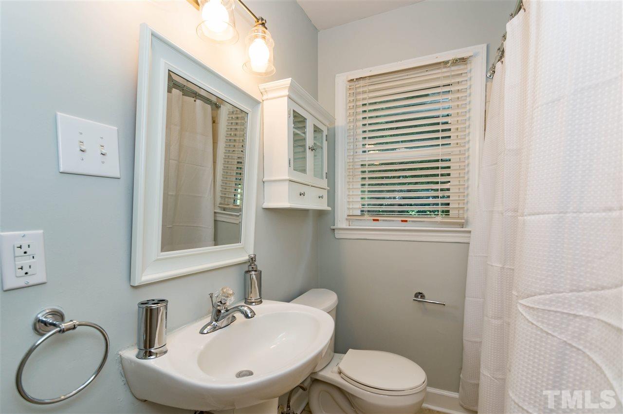 507 Brooks Avenue Raleigh, NC 27607 - Photo 14 of 20 a bathroom with a granite countertop toilet sink and mirror