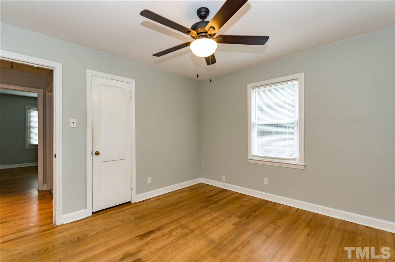 507 Brooks Avenue Raleigh, NC 27607 - Photo 16 of 20 a view of an empty room with window and wooden floor