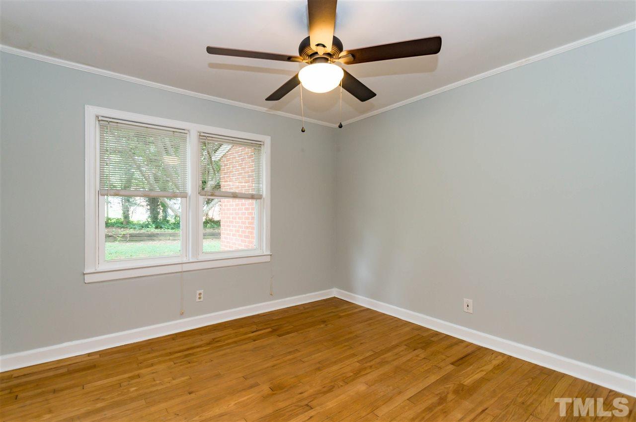 507 Brooks Avenue Raleigh, NC 27607 - Photo 17 of 20 a view of an empty room with window and chandelier fan