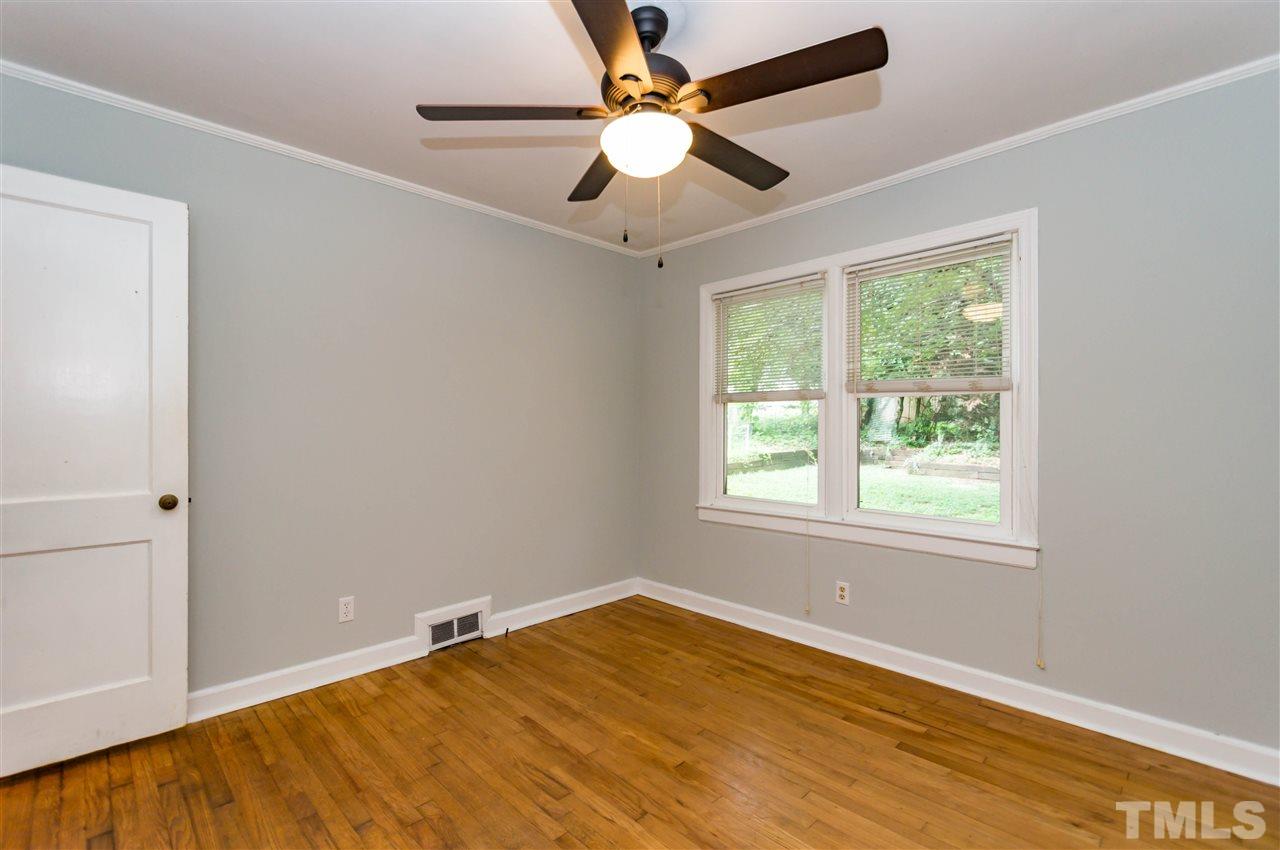 507 Brooks Avenue Raleigh, NC 27607 - Photo 18 of 20 a view of an empty room with window and chandelier fan