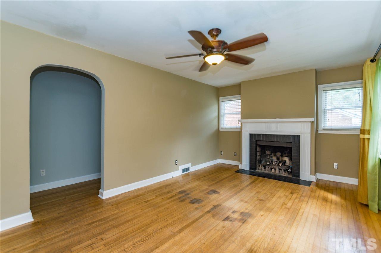 507 Brooks Avenue Raleigh, NC 27607 - Photo 3 of 20 a view of empty room with wooden floor and fireplace