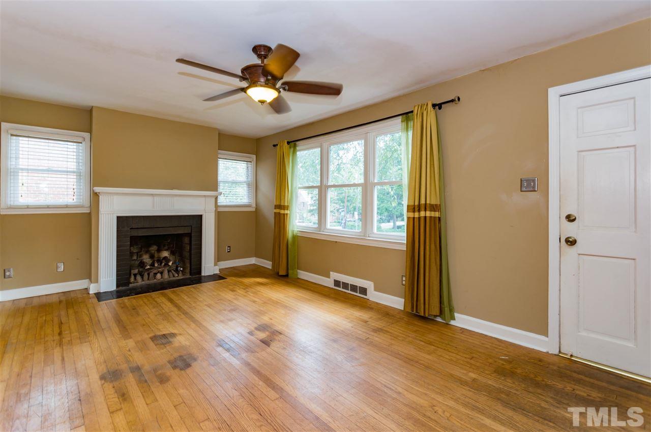507 Brooks Avenue Raleigh, NC 27607 - Photo 5 of 20 a view of an empty room with a fireplace and a window