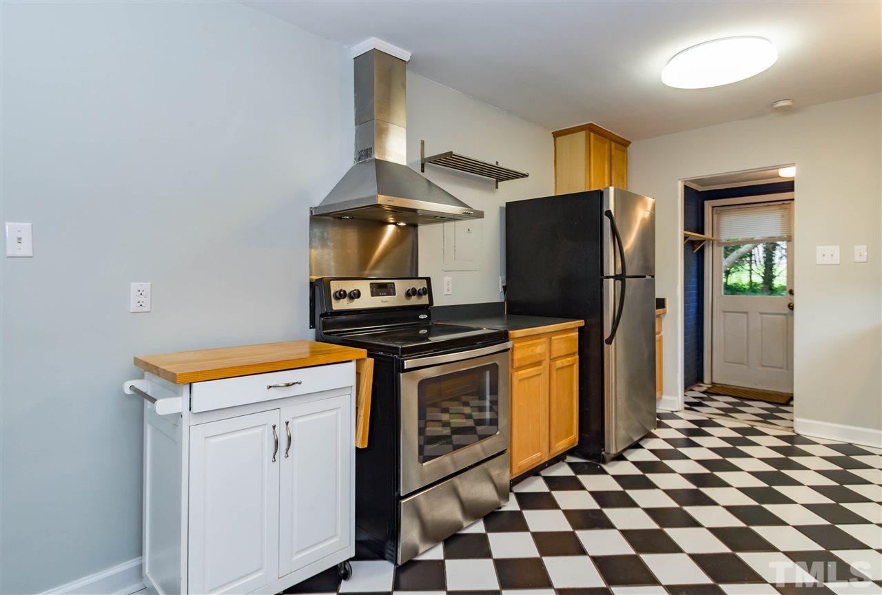 507 Brooks Avenue Raleigh, NC 27607 - Photo 7 of 20 a kitchen with stainless steel appliances granite countertop a stove a refrigerator and a sink