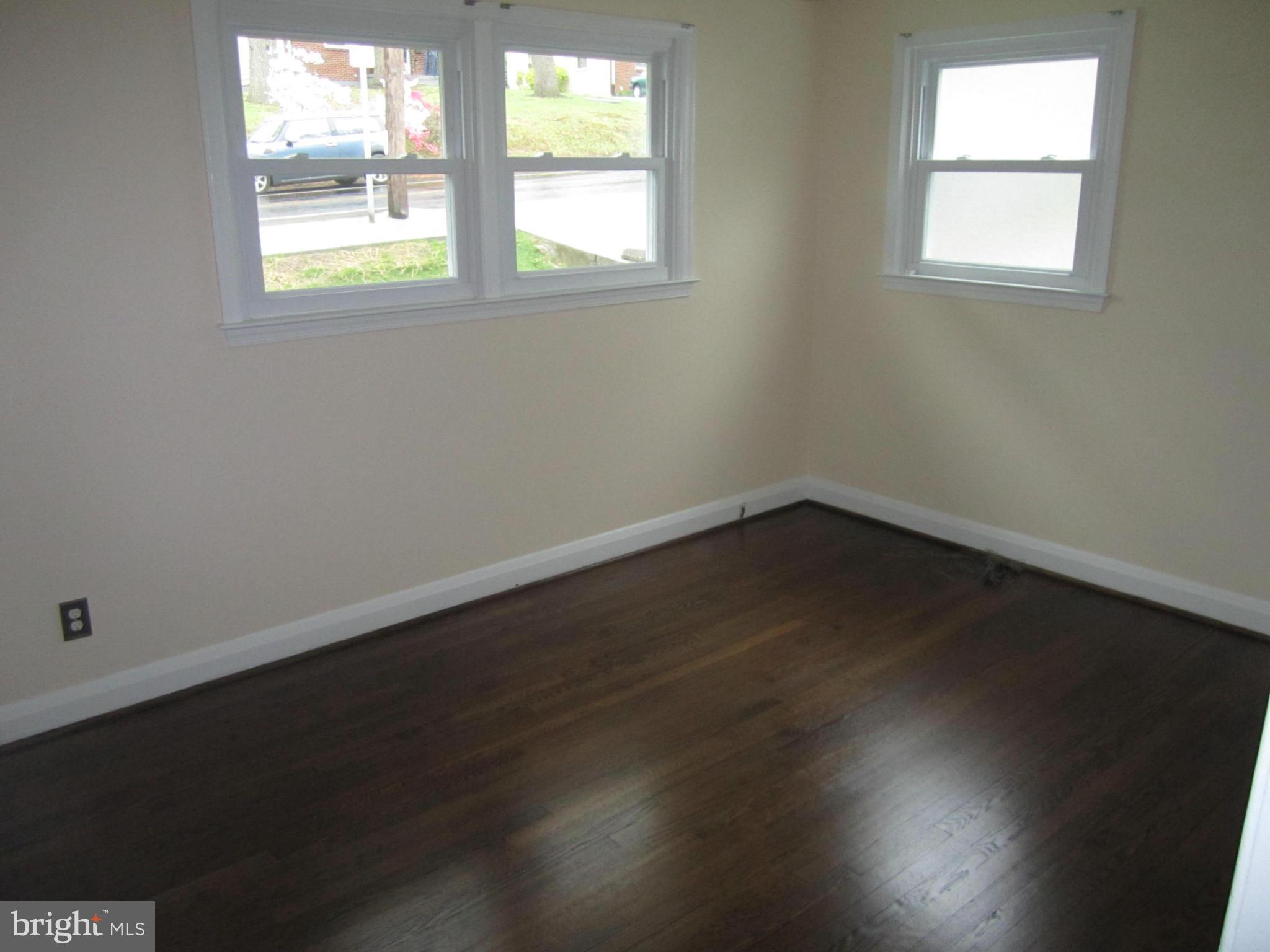 424 West Maple Road Linthicum, MD 21090 - Photo 12 of 24 an empty room with wooden floor and windows