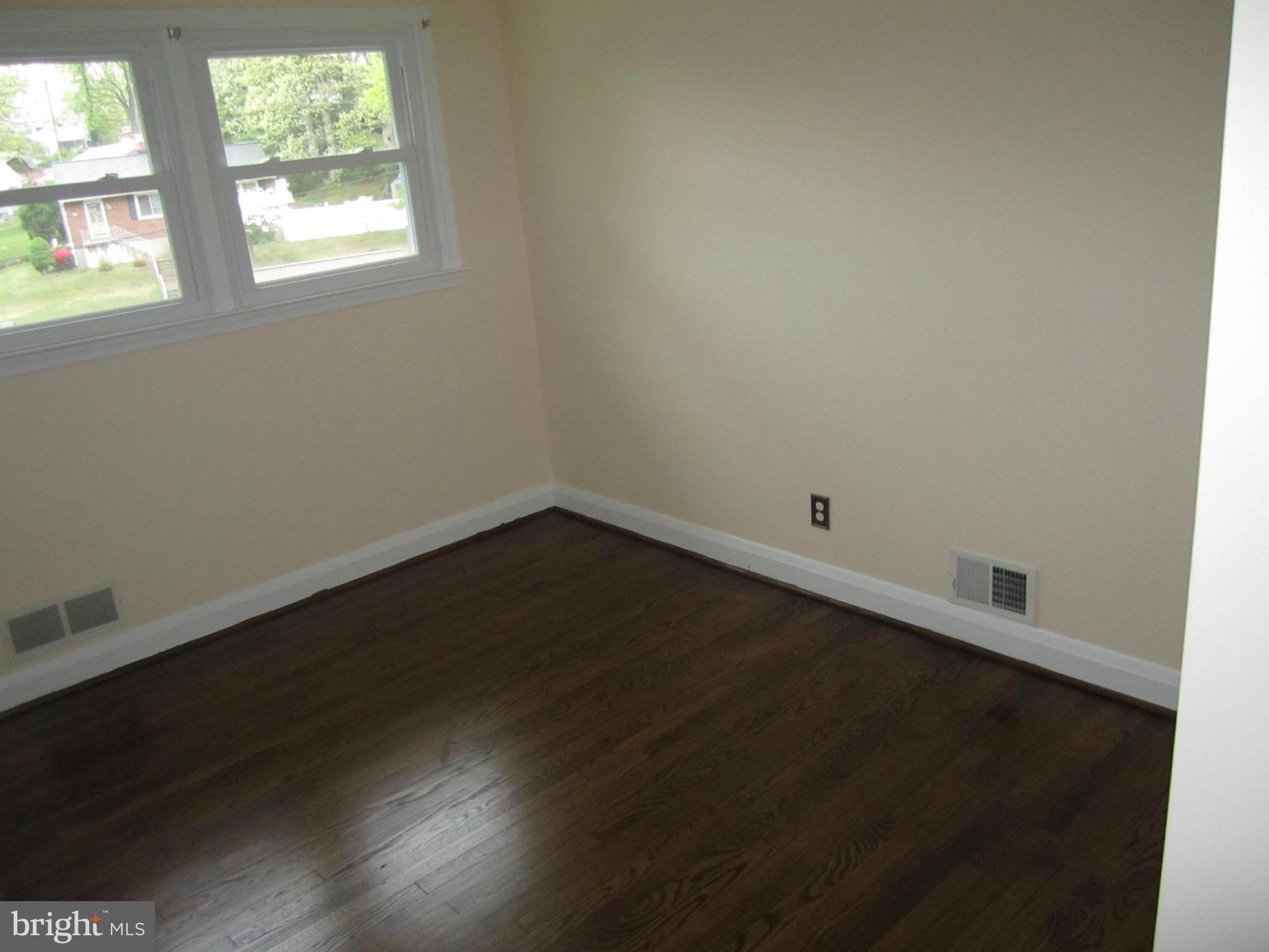 424 West Maple Road Linthicum, MD 21090 - Photo 14 of 24 an empty room with wooden floor and windows