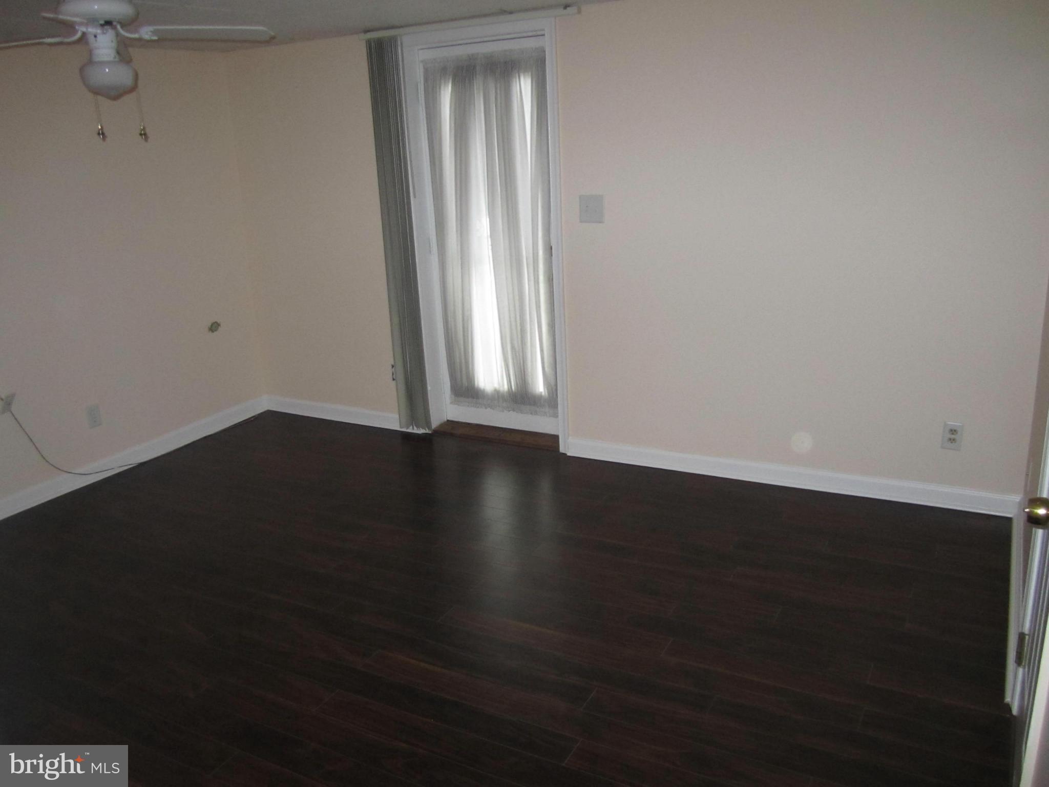 424 West Maple Road Linthicum, MD 21090 - Photo 20 of 24 an empty room with wooden floor and windows