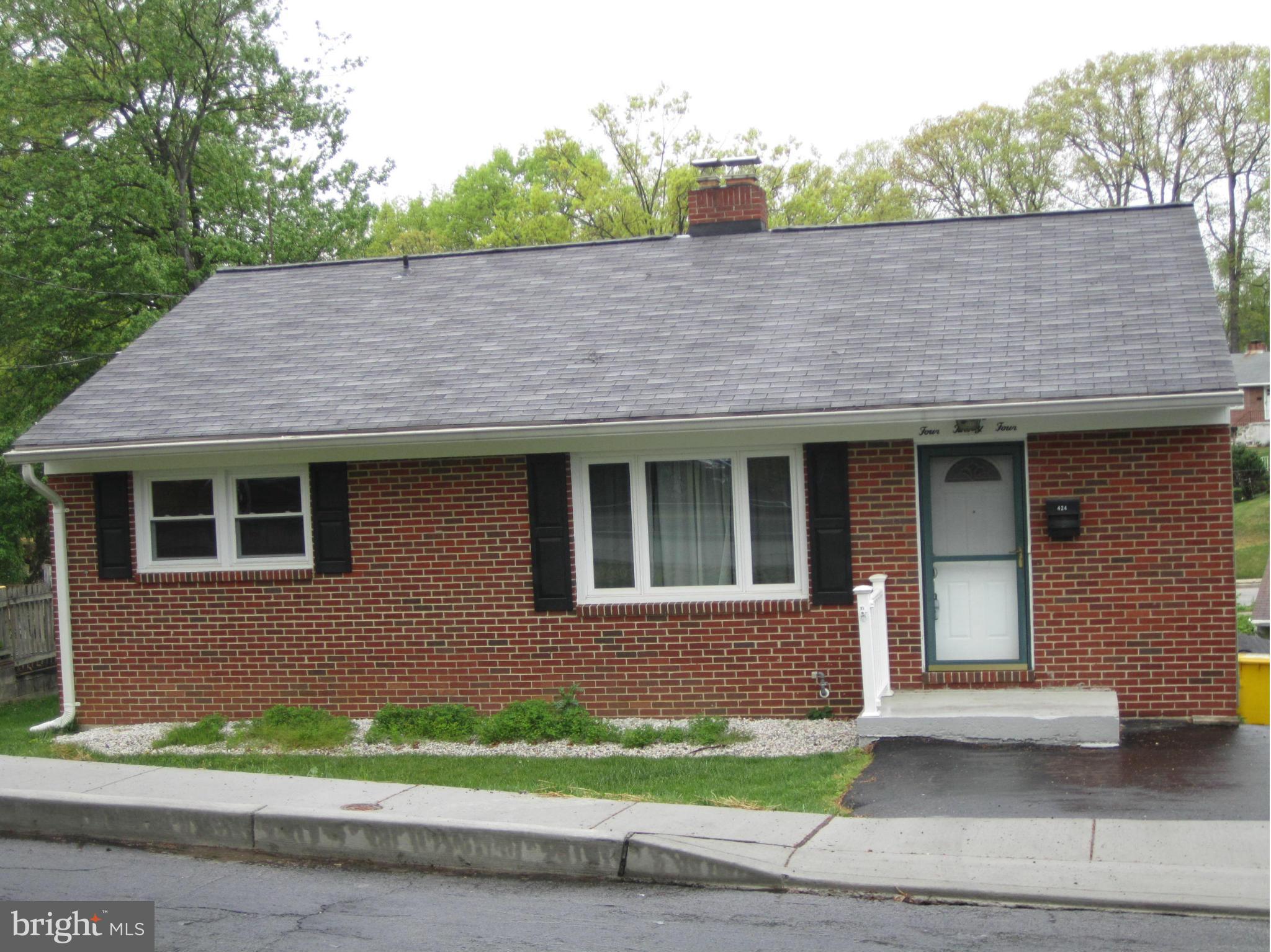 424 West Maple Road Linthicum, MD 21090 - Photo 4 of 24 a front view of a house with a garden and plants