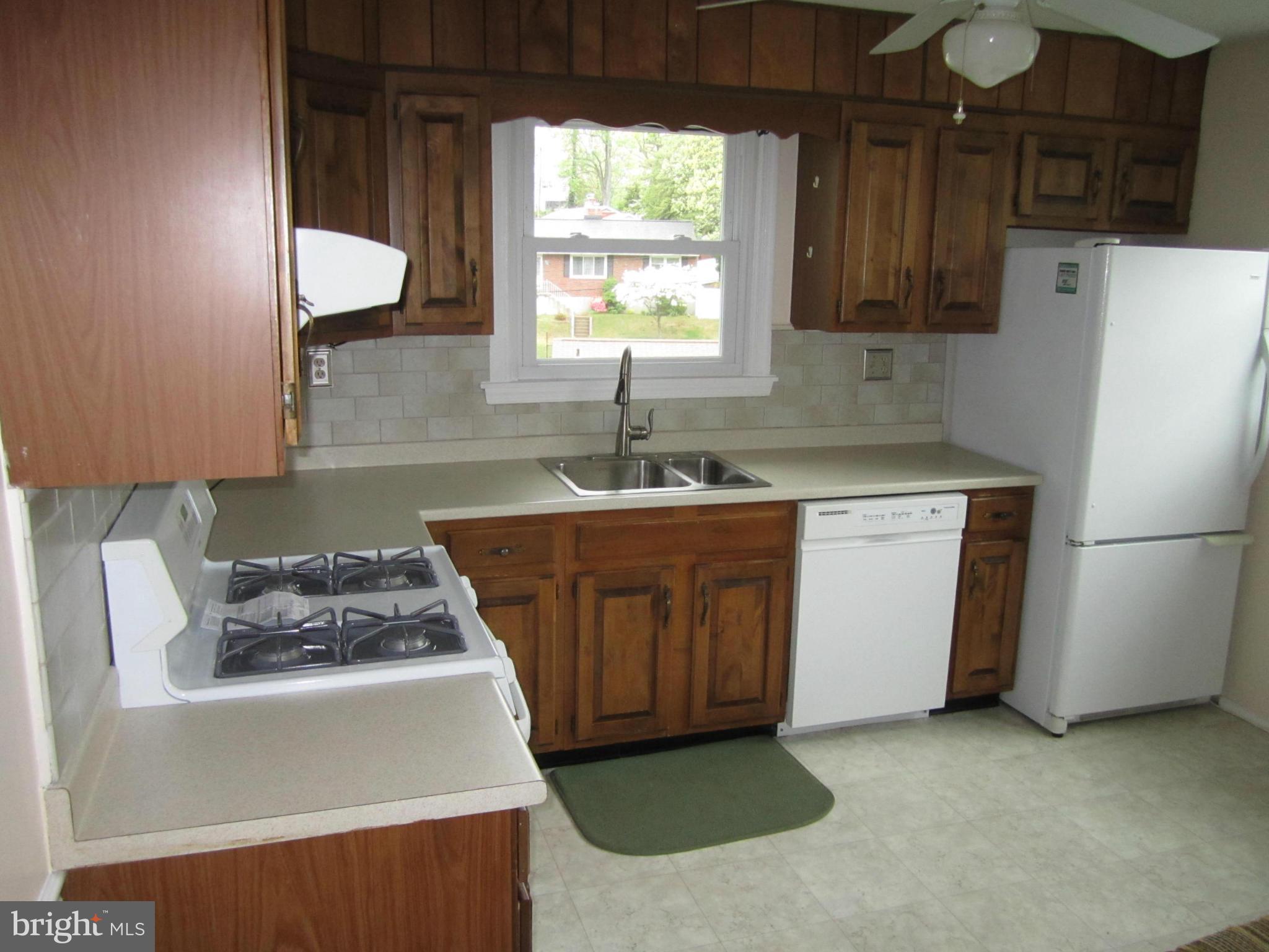 424 West Maple Road Linthicum, MD 21090 - Photo 7 of 24 a kitchen with sink a refrigerator and a stove