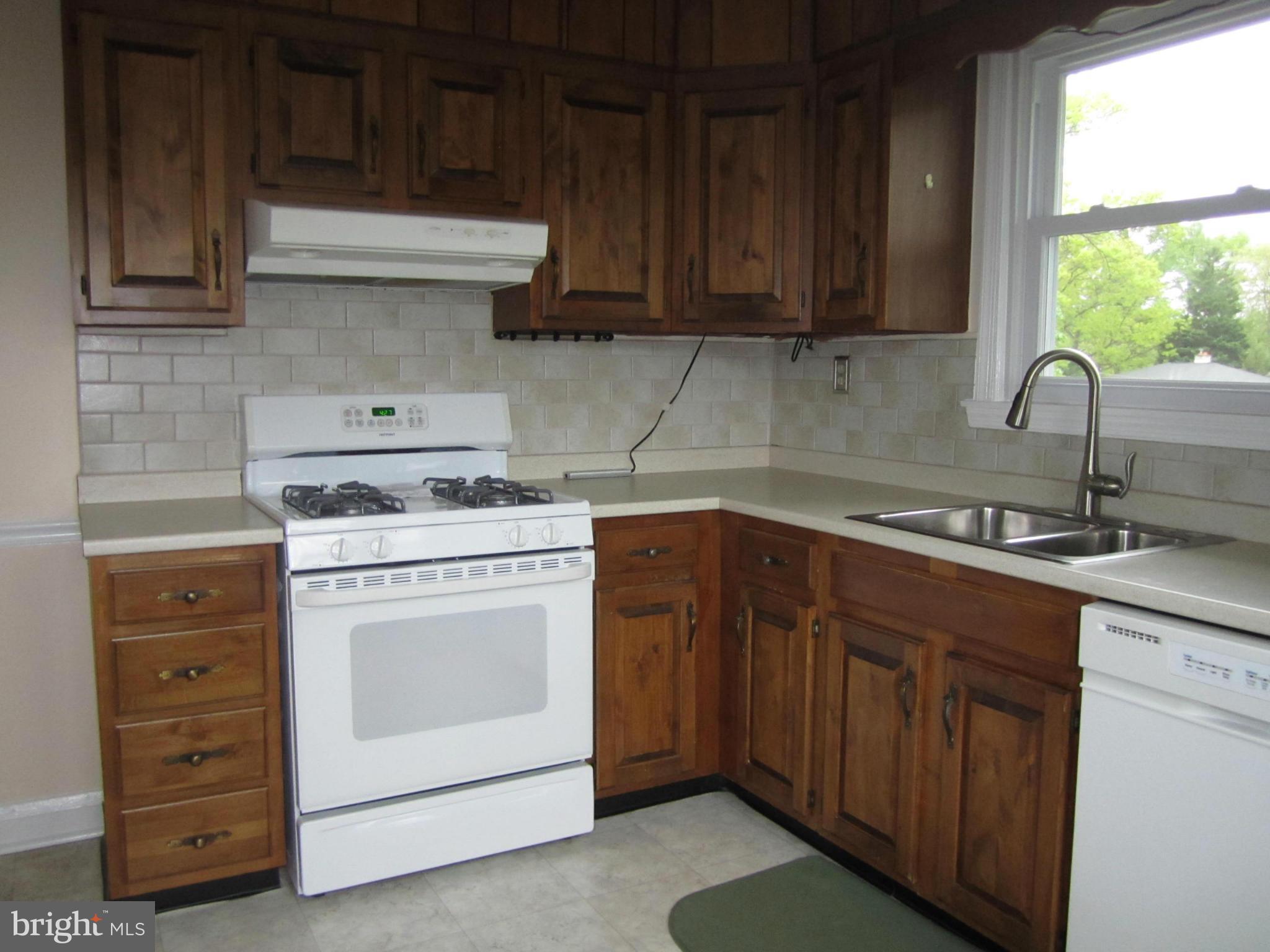 424 West Maple Road Linthicum, MD 21090 - Photo 9 of 24 a kitchen with sink a stove and cabinets