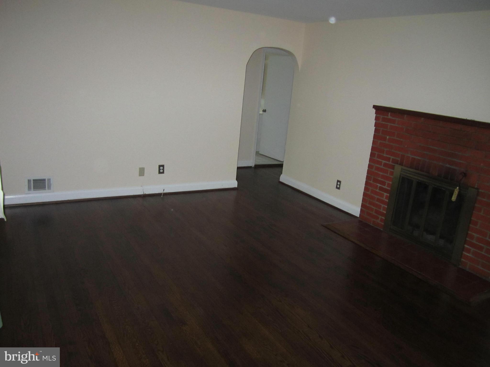 424 West Maple Road Linthicum, MD 21090 - Photo 10 of 24 a view of a room with wooden floor and a fireplace
