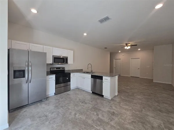 a kitchen with a refrigerator and a sink