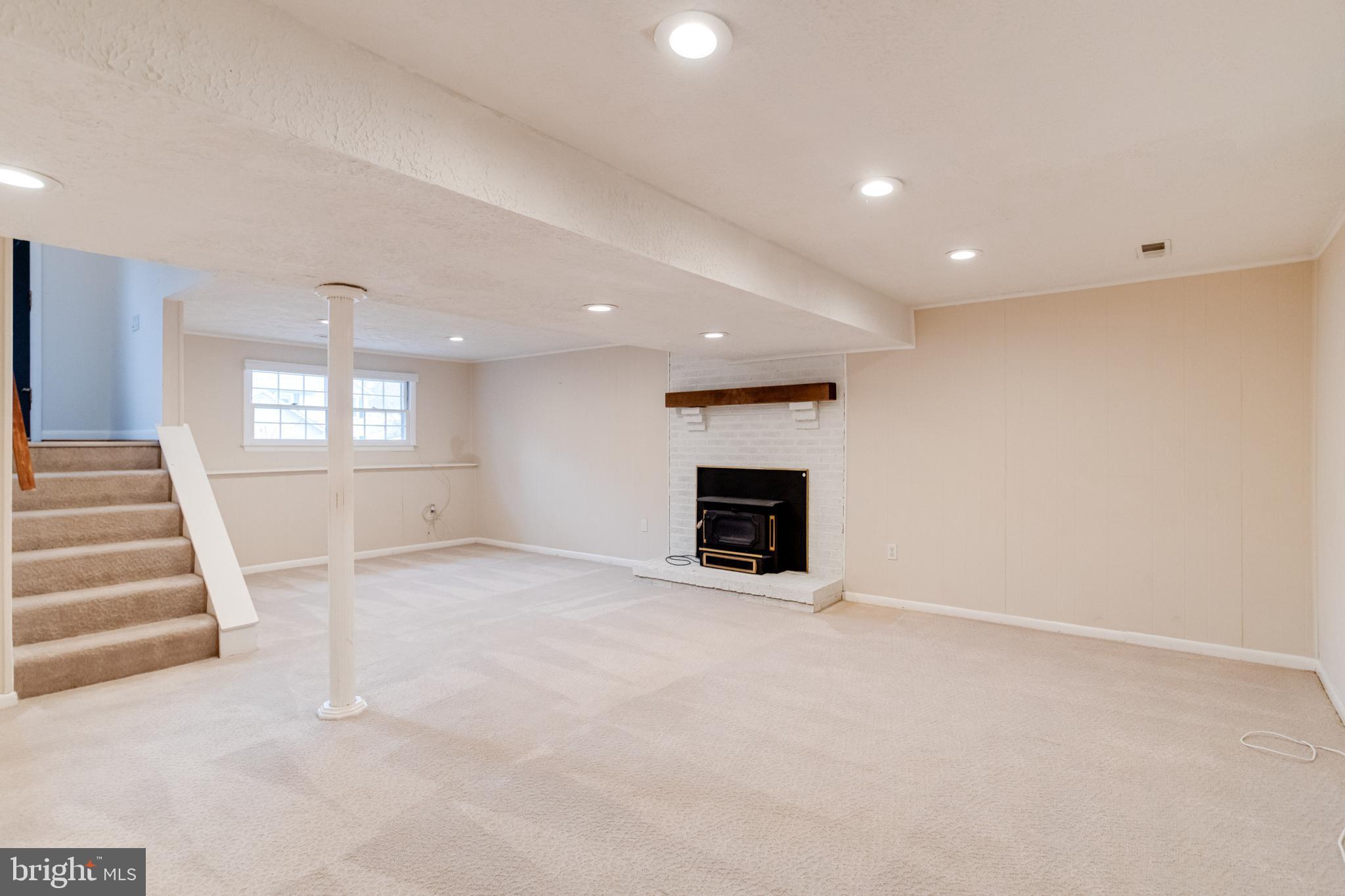 795 Windgate Drive Annapolis, MD 21409 - Photo 36 of 61 an empty room with fireplace and windows