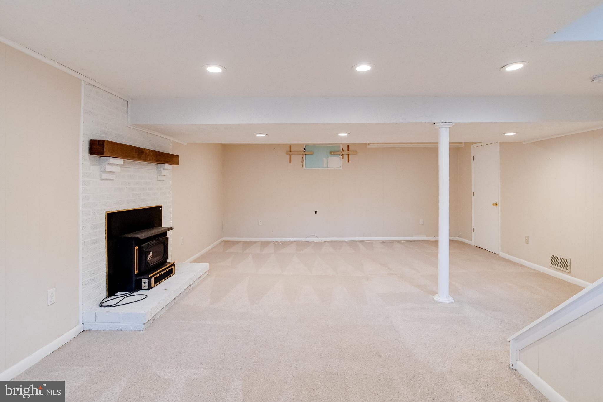 795 Windgate Drive Annapolis, MD 21409 - Photo 38 of 61 an empty room with a fireplace and natural light