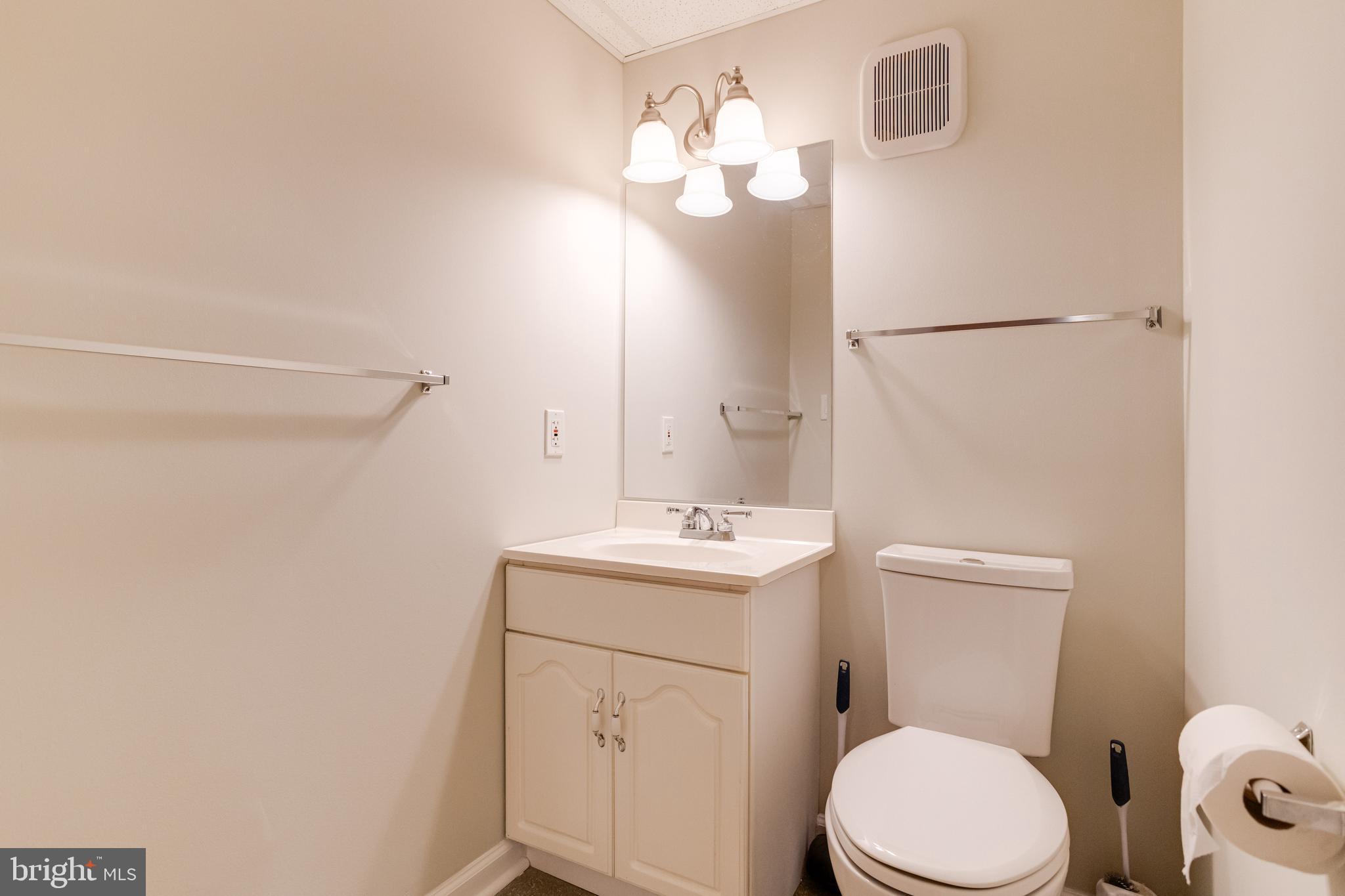 795 Windgate Drive Annapolis, MD 21409 - Photo 42 of 61 a bathroom with a toilet a sink and a mirror