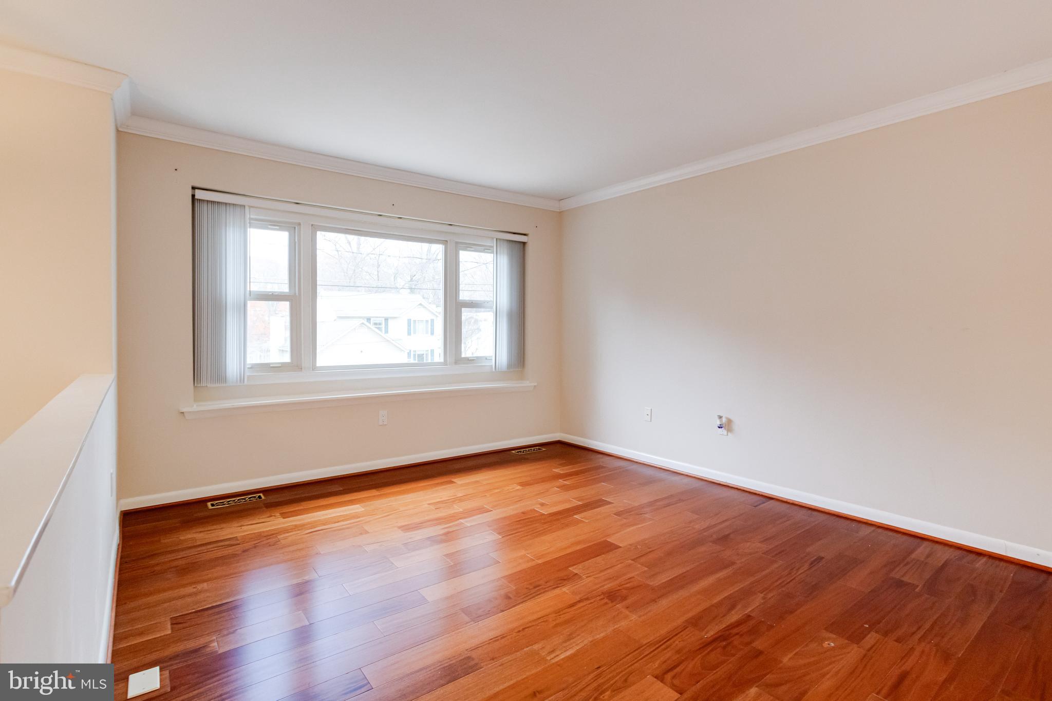 795 Windgate Drive Annapolis, MD 21409 - Photo 10 of 61 an empty room with wooden floor and windows