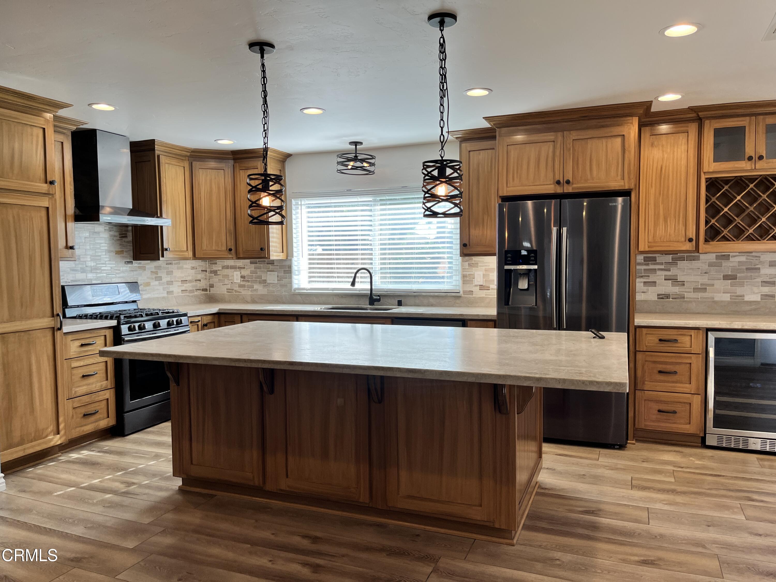 3540 Regatta Place Oxnard, CA 93035 - Photo 3 of 17 a large kitchen with stainless steel appliances granite countertop a stove a sink and a refrigerator