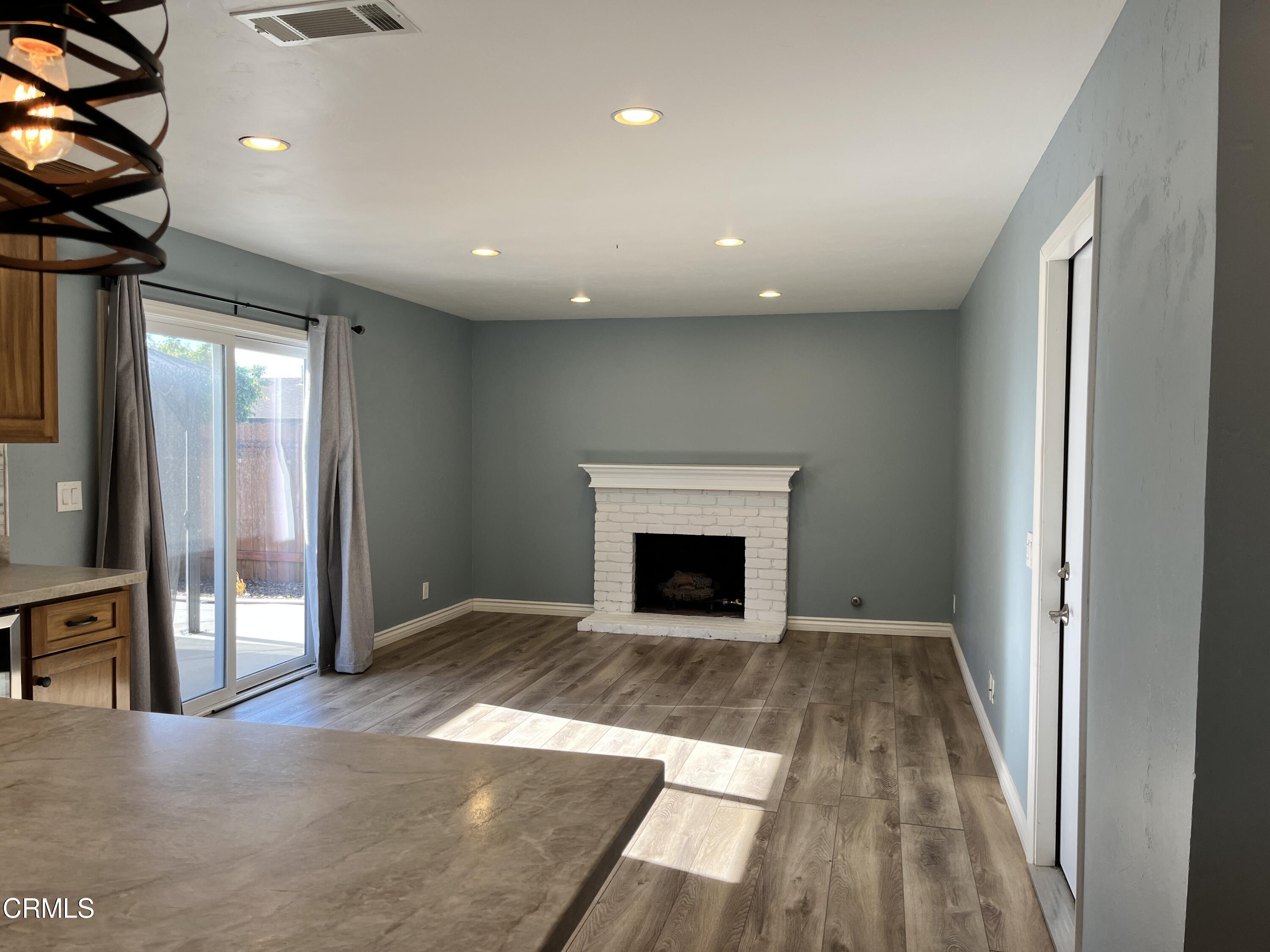 3540 Regatta Place Oxnard, CA 93035 - Photo 4 of 17 wooden floor in a hall with a fireplace