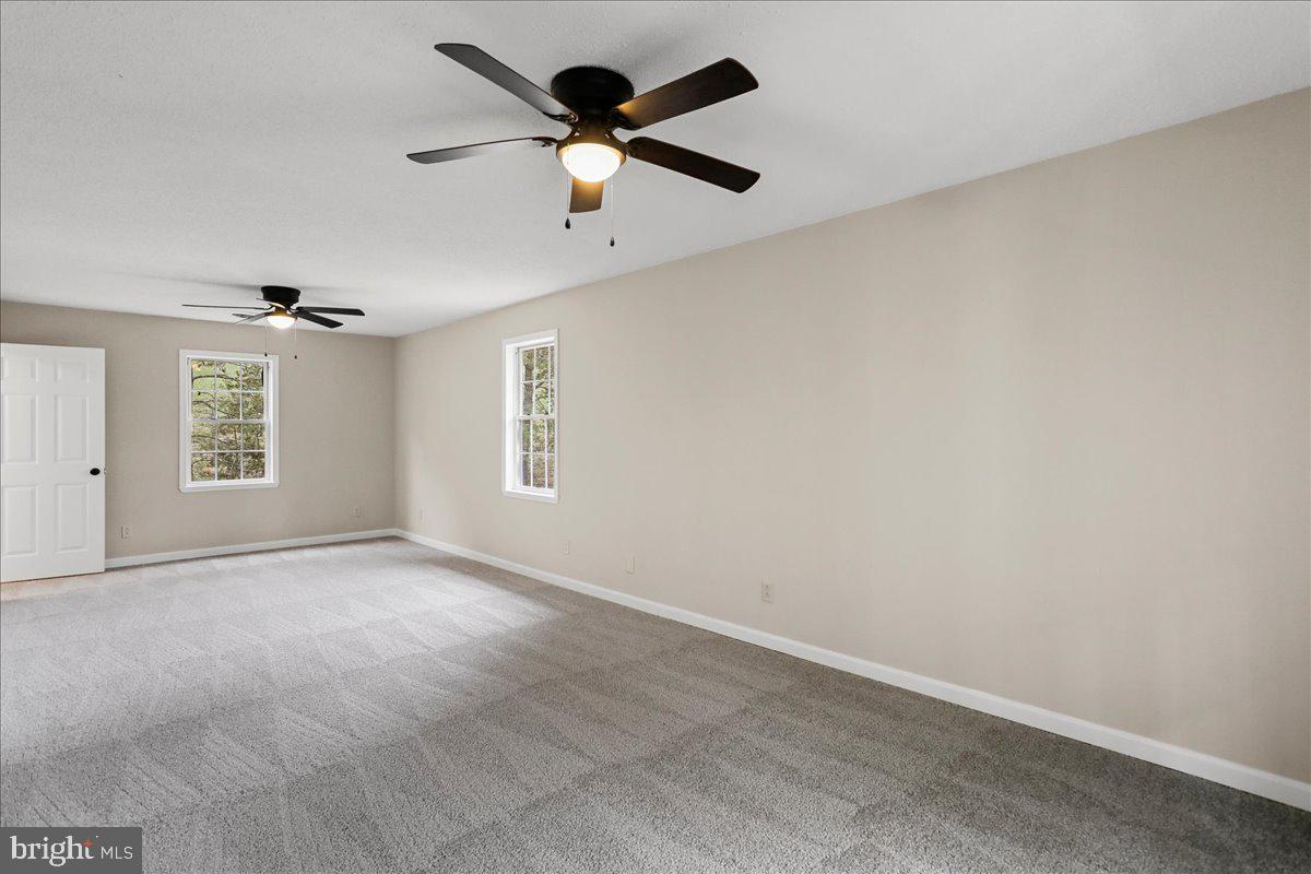 72 Pioneer Lane Berkeley Springs, WV 25411 - Photo 15 of 35 an empty room with windows and fan