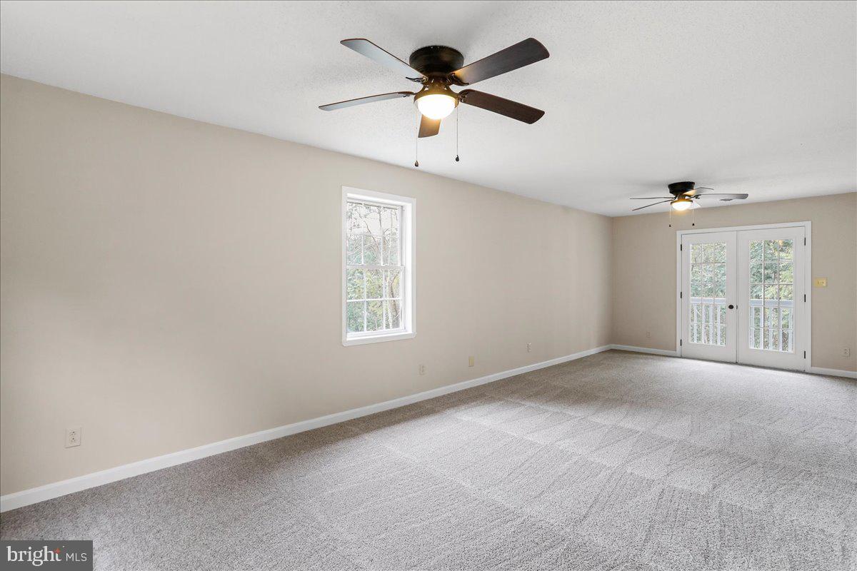 72 Pioneer Lane Berkeley Springs, WV 25411 - Photo 19 of 35 an empty room with fan and windows