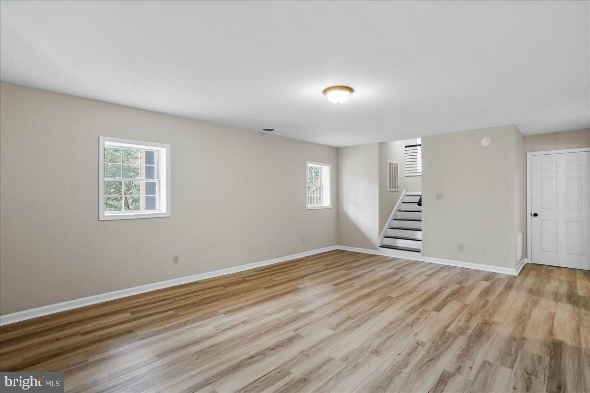 72 Pioneer Lane Berkeley Springs, WV 25411 - Photo 23 of 35 a view of an empty room with wooden floor and a window