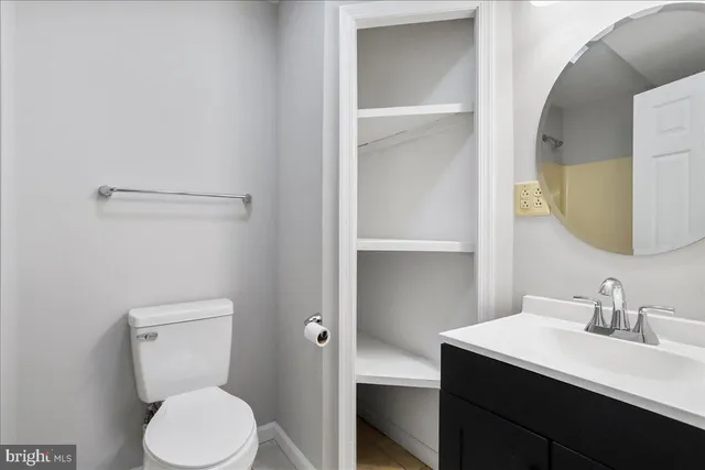 a bathroom with a toilet a sink and mirror