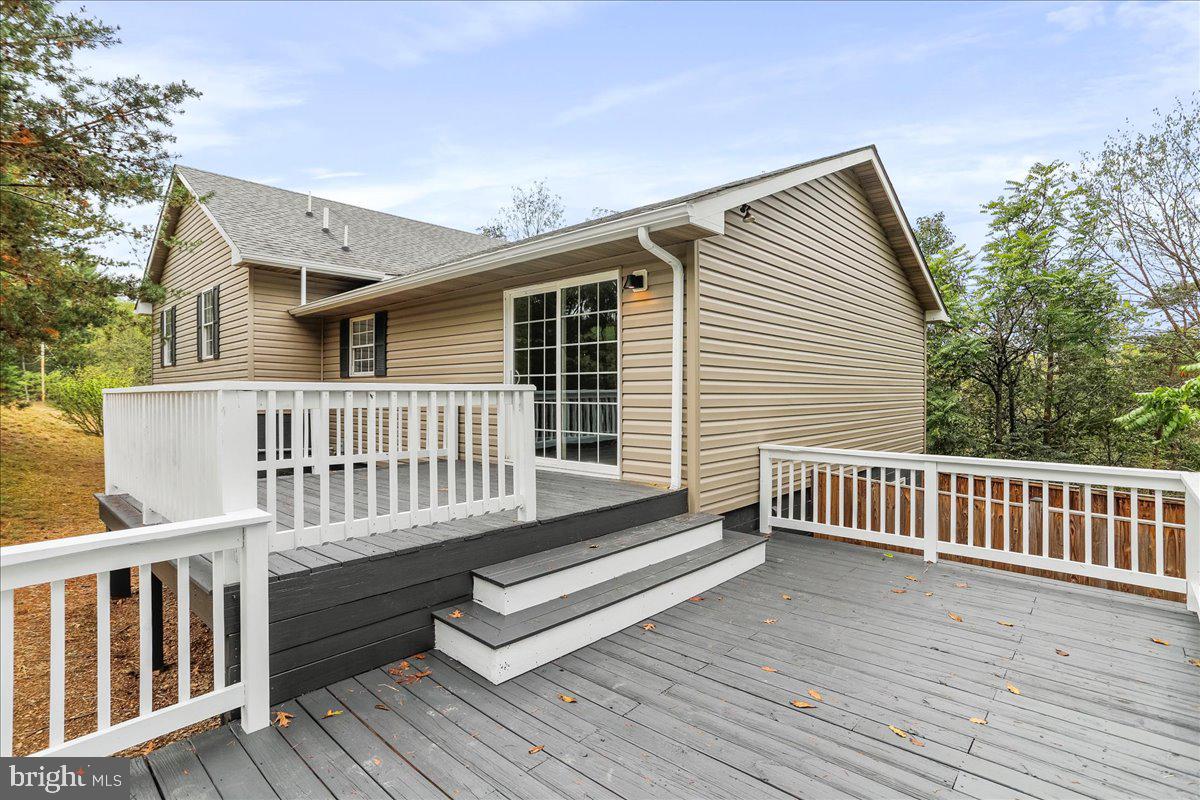 72 Pioneer Lane Berkeley Springs, WV 25411 - Photo 3 of 35 a view of a wooden chairs on deck
