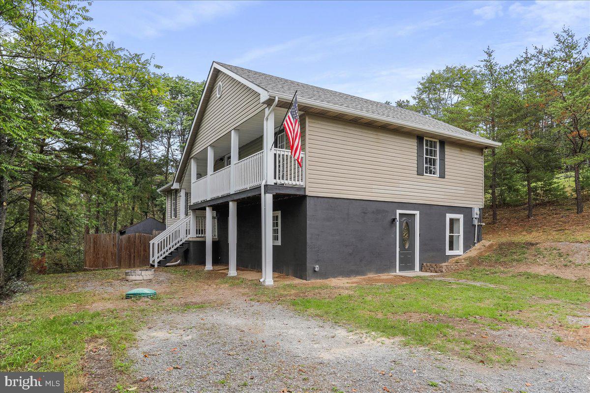 72 Pioneer Lane Berkeley Springs, WV 25411 - Photo 5 of 35 a front view of a house with a yard