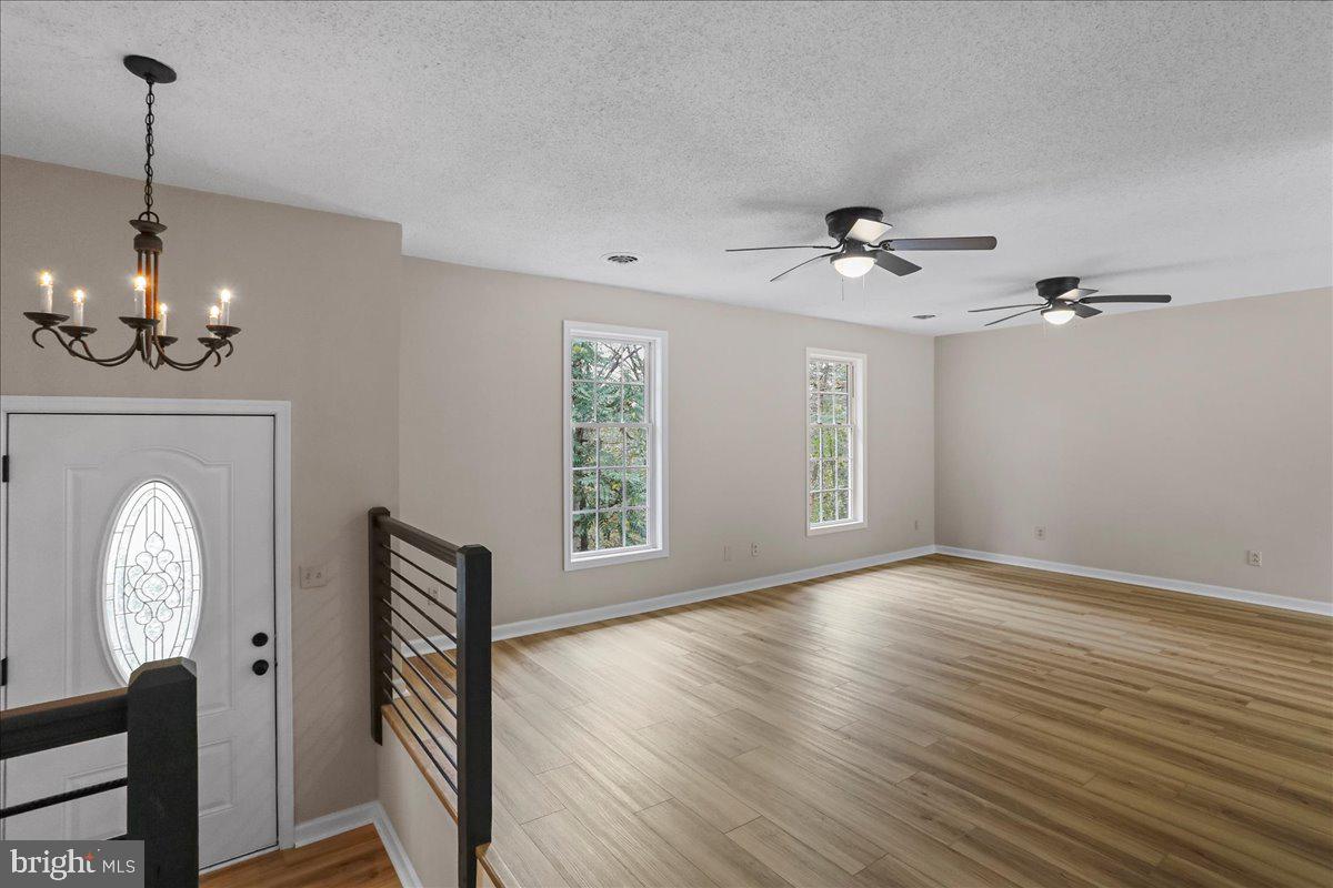 72 Pioneer Lane Berkeley Springs, WV 25411 - Photo 9 of 35 a view of a livingroom with furniture wooden floor a chandelier