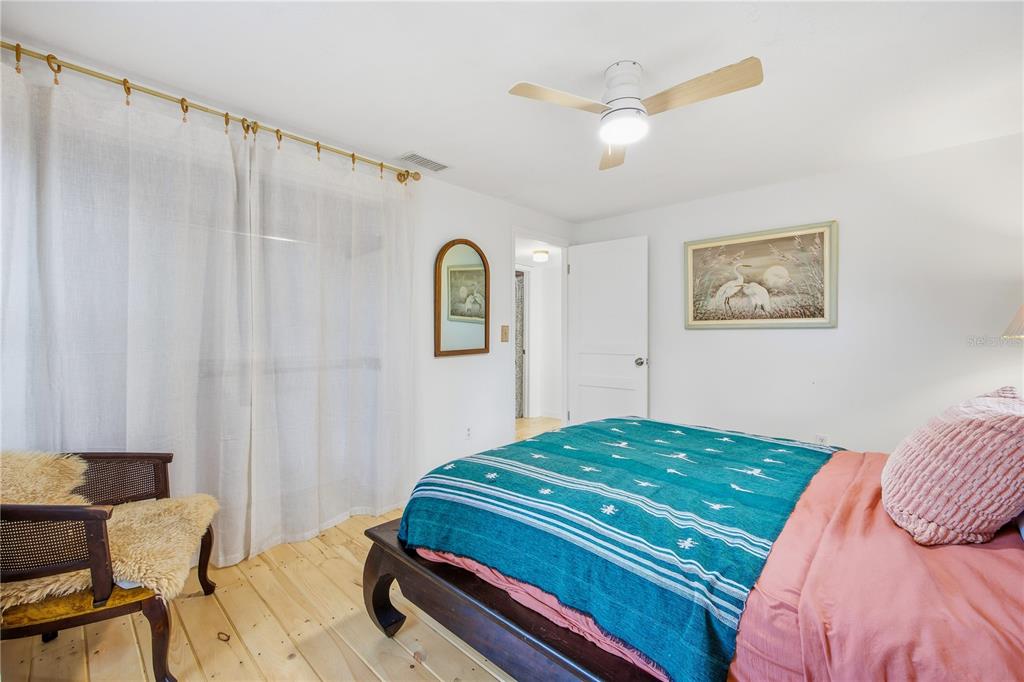 23422 Northeast 154th Place Road Salt Springs, FL 32134 - Photo 12 of 29 a bedroom with a bed and a table in it