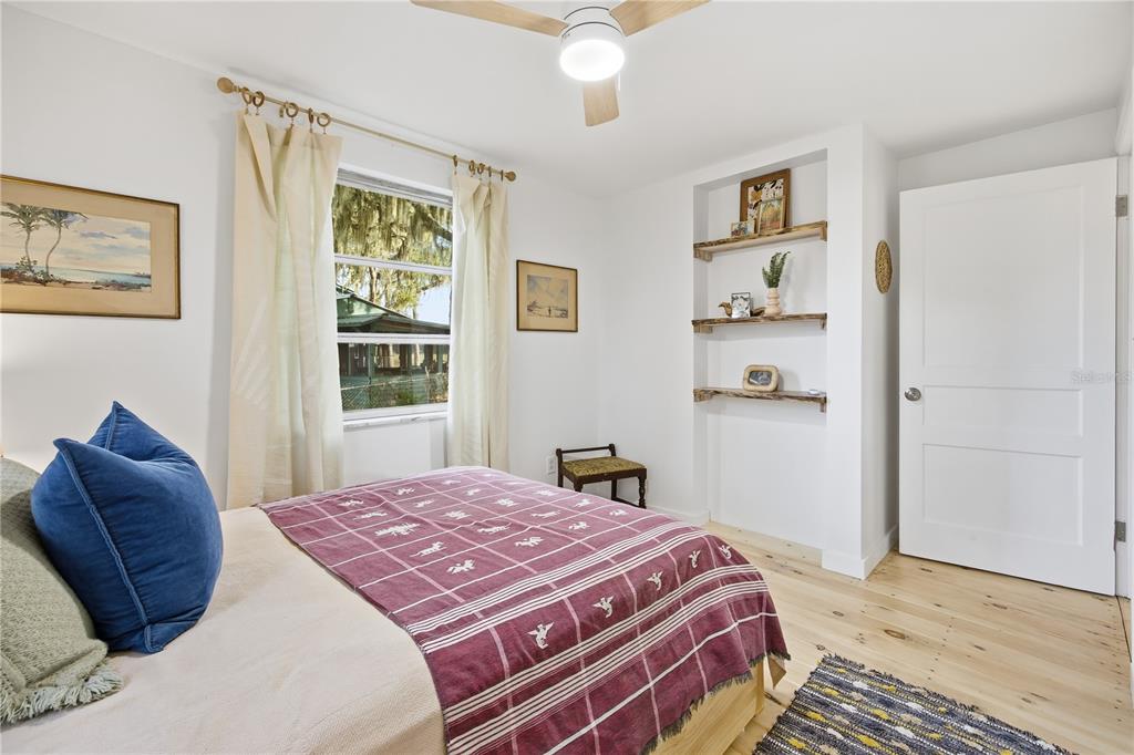 23422 Northeast 154th Place Road Salt Springs, FL 32134 - Photo 14 of 29 a bedroom with a large bed and a window