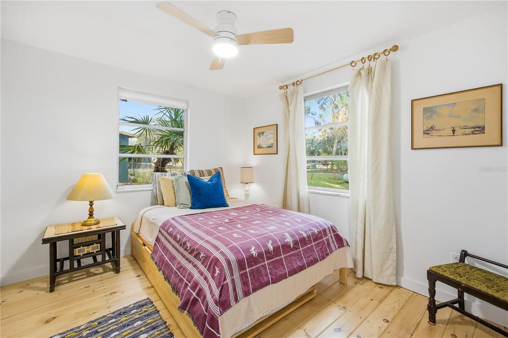 23422 Northeast 154th Place Road Salt Springs, FL 32134 - Photo 15 of 29 a bedroom with a bed and a window