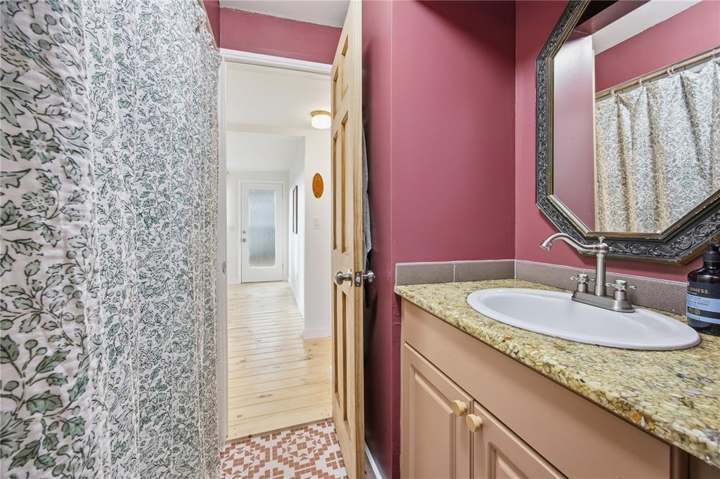 23422 Northeast 154th Place Road Salt Springs, FL 32134 - Photo 16 of 29 a bathroom with a granite countertop sink and a mirror