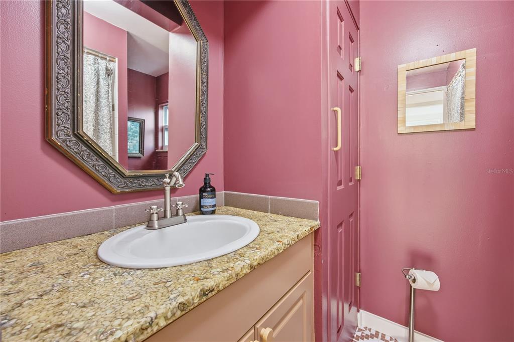 23422 Northeast 154th Place Road Salt Springs, FL 32134 - Photo 17 of 29 a bathroom with a granite countertop sink and a mirror
