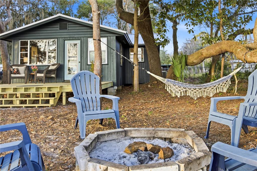 23422 Northeast 154th Place Road Salt Springs, FL 32134 - Photo 19 of 29 a front view of a house with outdoor seating