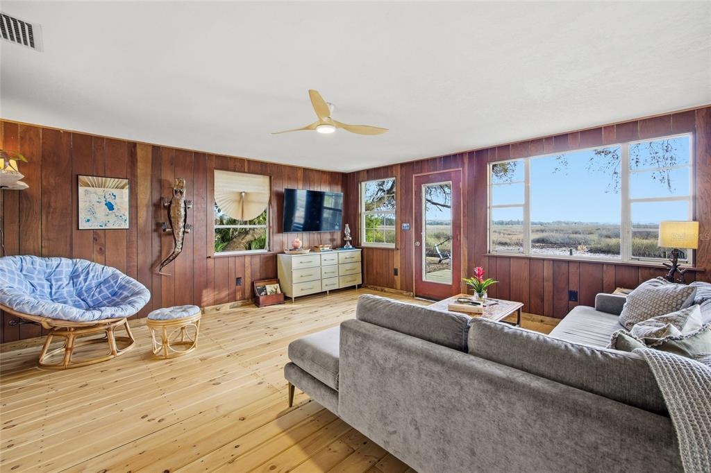 23422 Northeast 154th Place Road Salt Springs, FL 32134 - Photo 3 of 29 a living room with furniture kitchen view and a large window