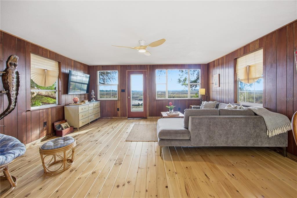 23422 Northeast 154th Place Road Salt Springs, FL 32134 - Photo 4 of 29 a living room with furniture and a large window