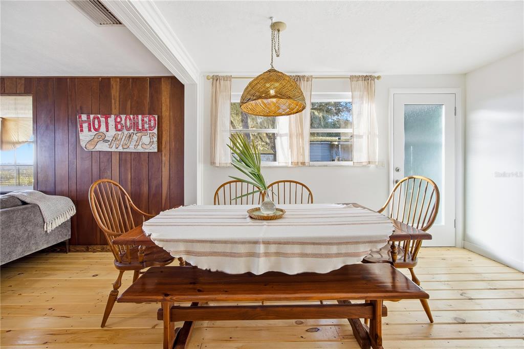 23422 Northeast 154th Place Road Salt Springs, FL 32134 - Photo 6 of 29 a view of a dining room with furniture window and wooden floor