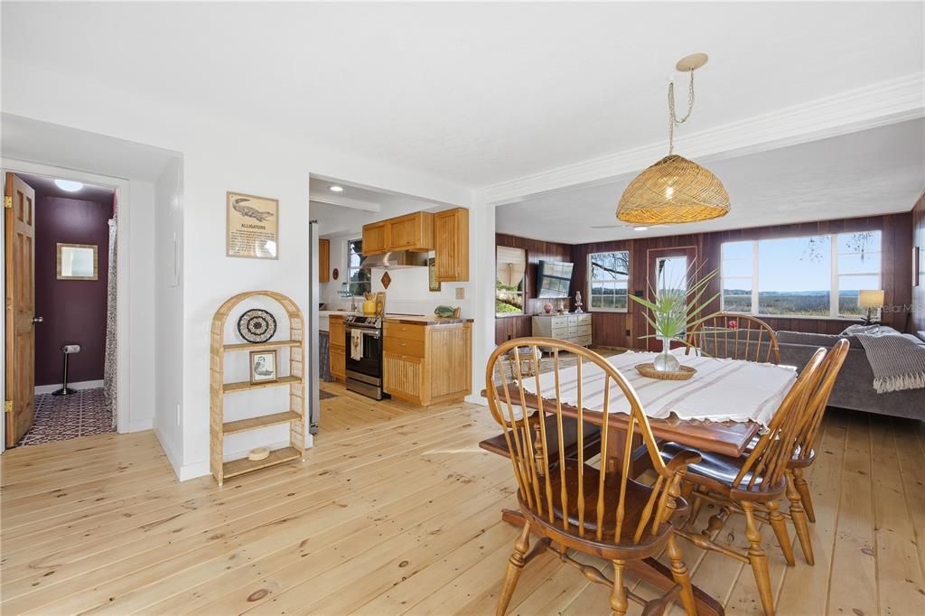23422 Northeast 154th Place Road Salt Springs, FL 32134 - Photo 8 of 29 a view of a dining room with furniture window and wooden floor